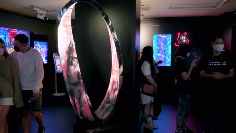 Chinese-visitors-look-at-digital-artworks-during-the-Digital-Art-Fair-showcasing-interactive-Web-3