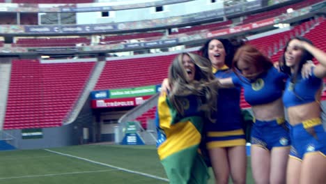 Group-of-female-Brazilian-football-fans-celebrate-in-stadium