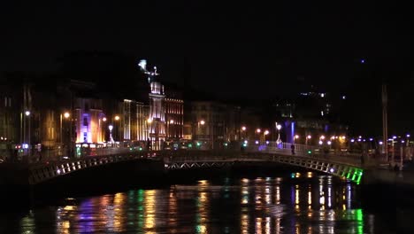 Wide-still-shot-of-the-happiny-bridge-in-Dublin-city-with-people-walking-over-it