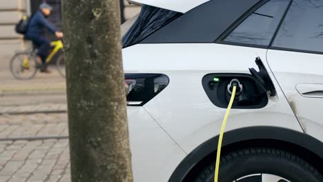 Charging-an-electric-car-with-the-power-cable-supply-on-a-street
