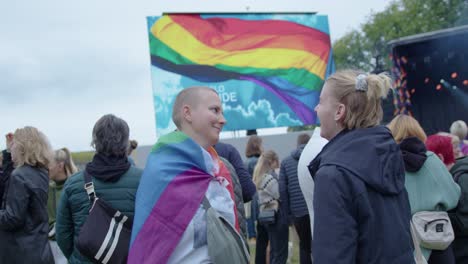 Two-female-friends-enjoying-Oslo-Pride-2022,-tilting-up-view