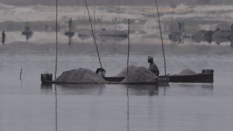 A-shot-of-two-salt-extraction-workers-in-the-Dakar-lake,-Senegal
