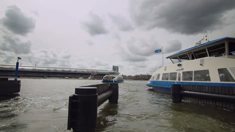 Amsterdam-ferries-exchanging-on-Buiksloterweg-shore,-Holland,-Static-Timelapse-shot,-4K