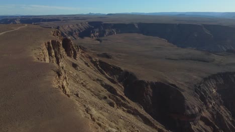 Drone-shot-of-the-Fish-River-Canyon-in-Namibia---drone-is-ascending-near-the-edge-of-the-African-canyon
