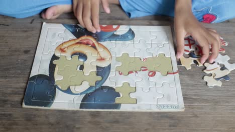 An-autistic-child's-hands-playing-a-puzzle-symbol-of-Public-awareness-for-autism-spectrum-disorder