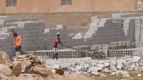 Two-workers-in-a-small-and-typical-brick-factory-in-Nouakchott,-Mauritania