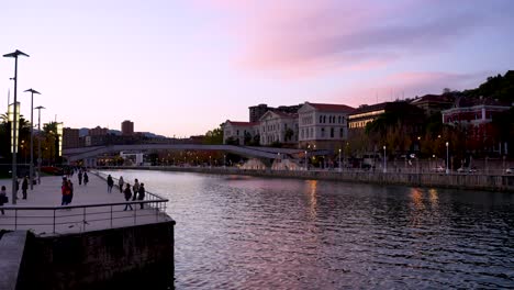 Pedro-Arrupe-Zubia-Bridge-over-the-Nervion-River-and-Deusto-University-on-the-right,-Wide-shot