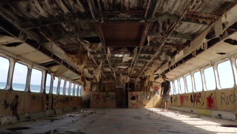 Male-Exploring-Inside-Abandoned-Derelict-Clipper-Boat
