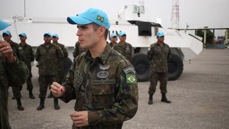 Squad-Peacekeeping-soldiers-stand-easy-beside-a-UN-armoured-personnel-carrier