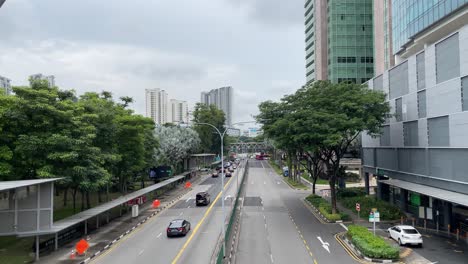 Top-view-of-cars-driving-on-the-road-at-Toa-Payoh,-Singapore