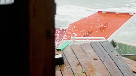 Slowmo-close-up-of-local-wooden-fishing-boat-being-smashed-into-pieces-during-sudden-storm-with-rough-waves,-Caribbean