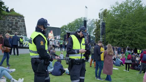 Norway-police-forces-guarding-Oslo-Pride-2022-event,-handheld-view