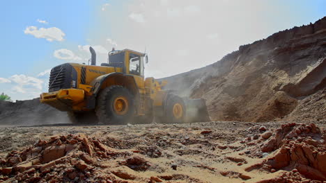 Volvo-wheel-loader-clearing-out-a-construction-site-foundation-in-slow-motion