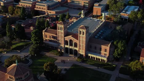 Royce-Hall-on-the-campus-of-the-University-of-California,-Los-Angeles-at-sunset---ascending-aerial-view