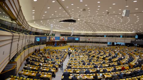 Wide-angle-panning-shot-of-the-European-Parliament-congress-plenary-hall-crowded-with-deputies---Brussels,-Belgium