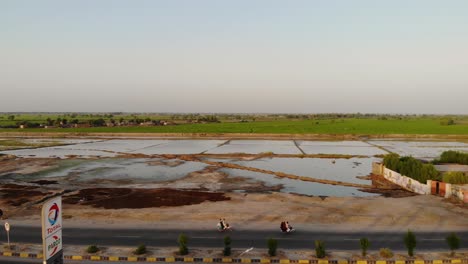Aerial-View-From-Across-Truck-Stop-In-Rural-Sindh-Of-Flooded-Fields