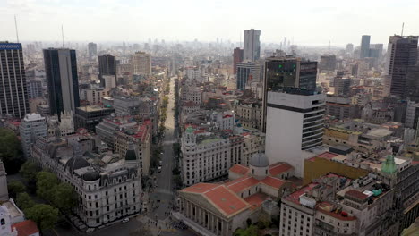 Sideways-aerial-of-long-avenue-and-skyline-of-Buenos-Aires,-Argentina