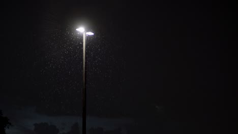 City-lights-during-rain-and-lightning-at-night
