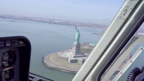 Inside-View-From-Control-Panel-Dashboard-Of-Helicopter-Flying-Past-Statue-Of-Liberty