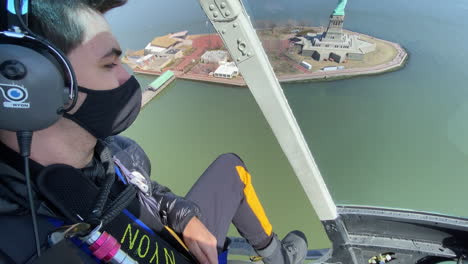 Passenger-Enjoying-Views-Of-Statue-Of-Liberty-from-Helicopter-Tour