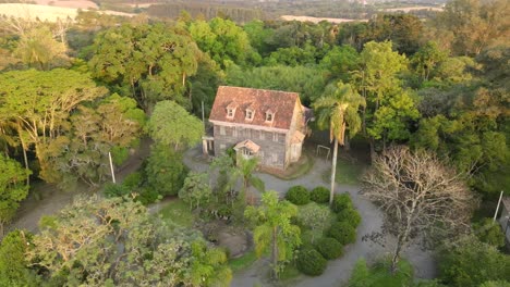 Palácio-do-Pinho,-is-a-historical-mansion-from-the-beginning-of-the-20th-century,-located-in-the-Irati-National-Forest,-in-the-state-of-Paraná,-Brazil,-drone-orbital-view