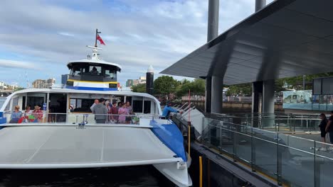 Ferry-operator-lower-the-ramp-at-South-Bank-terminal,-passenger-disembarking-translink-citycat-double-decker-ferry,-public-transportation-revolution-in-Brisbane,-Queensland,-Australia