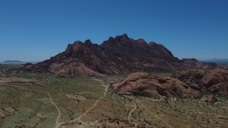 Drone-shot-of-Spitzkoppe-in-Namibia---drone-is-ascending-and-facing-the-beautiful-mountains