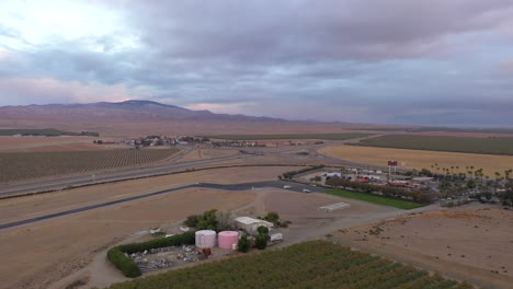 Aerial-view-of-grain-silos-and-farmland-at-Harris-Ranch,-Coalinga,-California