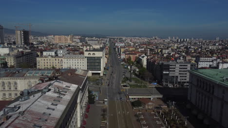 Drone-shot-of-Sofia-in-Bulgaria---drone-is-following-a-busy-street-in-the-center