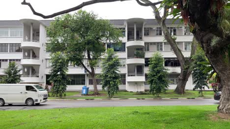 Vehicles-drive-along-the-low-rise-apartment-blocks-of-Tiong-Bahru-Estate