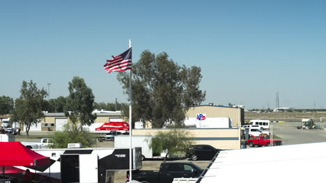 Slow-motion-of-American-flag-at-metal-pillar-waving-in-Buttonwillow-Raceway-Park