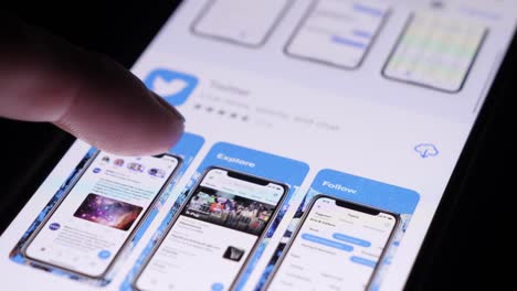 Finger-Tapping-On-App-Store-On-Smartphone-And-Installing-Twitter
