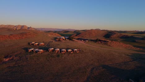 Drone-shot-of-the-Namib-Naukluft-during-sunset---drone-is-circling-around-an-indigenous-village-in-the-steppe