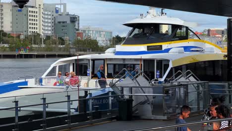 Translink-citycat-double-decker-ferry-departing-south-bank-terminal,-brand-new-boat-cruising-the-river-across-inner-city-suburbs,-public-transportation-revolution-in-Brisbane,-Queensland,-Australia