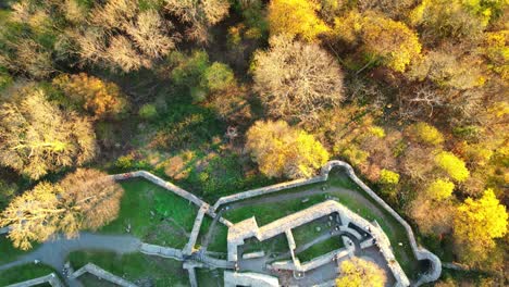 Bird's-eye-view-of-the-castle-ruins-Löwenburg-on-the-hill-top-called-Löwenburg-in-the-Siebengebirge-during-late-afternoon-while-the-sun-was-setting-in-Autumn