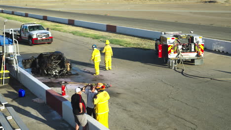 Rescue-Team-of-Firefighters-and-Paramedics-Work-on-a-Car-Explosion-near-the-racetrack
