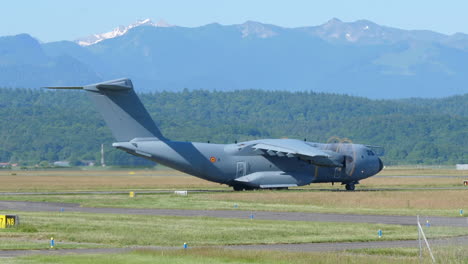 Military-Cargo-Aircraft-Airbus-A400-at-Airport,-Mountain-Background