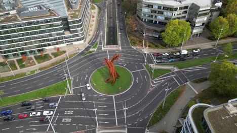 A-tilt-upward-aerial-view-of-the-iconic-Helmut-Schmidt-Platz-on-the-B9-road-in-Bonn,-Germany,-showing-the-ARC'89-sculpture-by-Bernar-Venet
