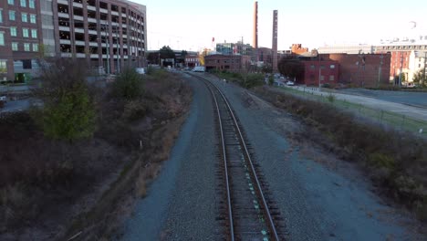 Train-Track-leading-into-downtown-Winston-Salem,-NC-with-RJR-towers-in-background