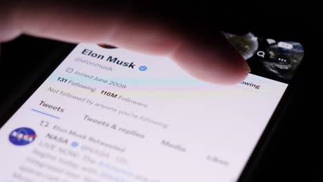 Hand-Tapping-On-Twitter-Icon-On-Smartphone-And-Unfollowing-Elon-Musk