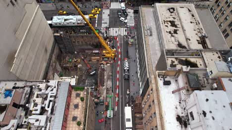 Aerial-overview-of-a-construction-site-in-middle-of-buildings-in-Midtown,-NYC