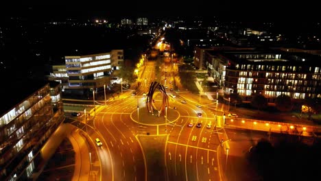Night-time-push-forward-aerial-view-of-the-Helmut-Schmidt-Platz-Artwork-on-the-B9-in-Bonn,-Germany