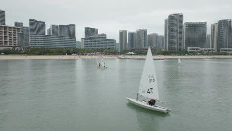 Sailing-boat-club-exercises-by-the-beach-shore-in-Huizhou,-China