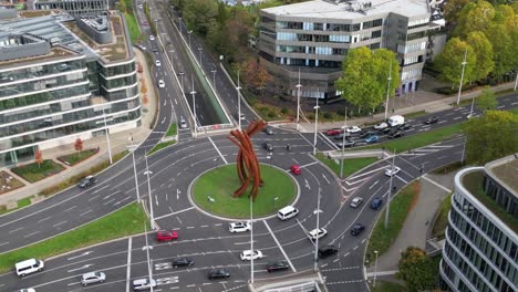 A-panning-aerial-view-of-the-iconic-Helmut-Schmidt-Platz-on-the-B9-road-in-Bonn,-Germany,-showing-the-ARC'89-sculpture-by-Bernar-Venet
