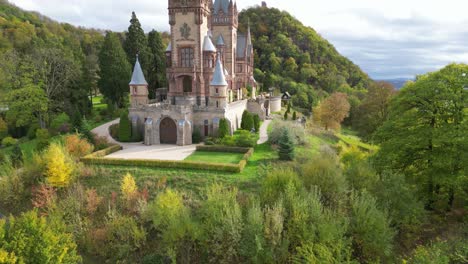 Tilting-shot-of-the-Drachenburg-Castle-on-the-Drachenfels-hills-in-Königswinter-on-a-cool-autumn-day