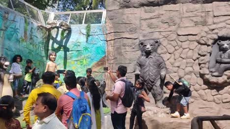People-Taking-Photos-Of-The-Children-With-Mowgli-and-Bhalu-Standing-Side-By-Side-At-The-Zoo