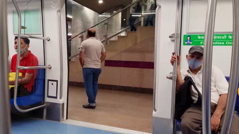 passenger-in-metro-deboarding-at-metro-station-from-back-video-is-taken-at-new-delhi-metro-station-new-delhi-india-on-Apr-10-2022