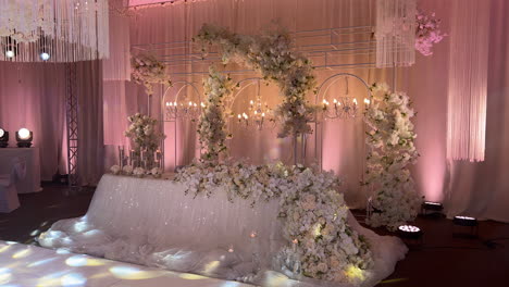 Beautifully-decorated-wedding-table-with-artificial-flowers-and-illuminated