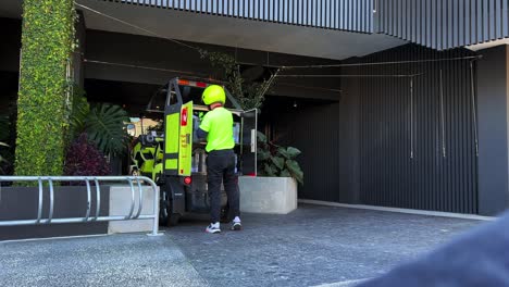 Australia-post-postman-driving-battery-operated-electric-vehicle-on-the-road-delivering-parcels-to-door,-technology-transformation,-reducing-environmental-impact-and-combatting-climate-change