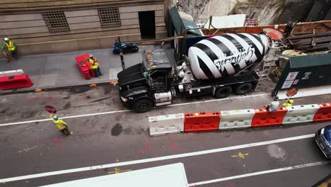 Aerial-view-around-a-concrete-mixer-truck-at-a-construction-site-in-NYC---circling,-drone-shot